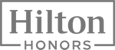 The image displays the logo for "Hilton Honors," a rewards program by Hilton Hotels, featuring the text in bold, framed by a rectangular border.