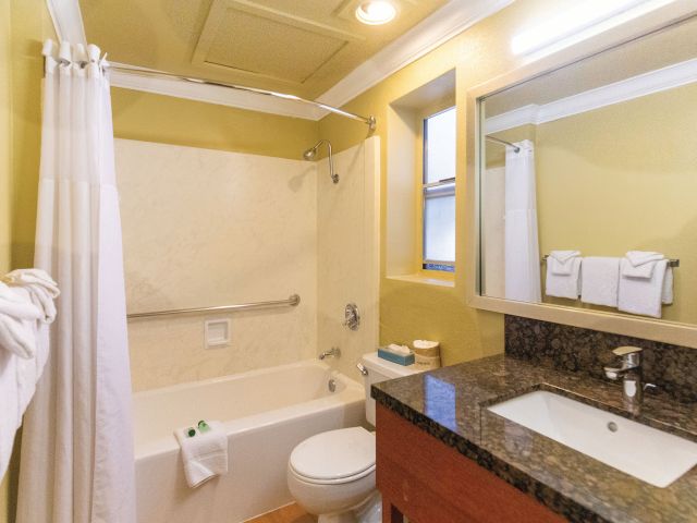 A clean bathroom with a bathtub, toilet, and sink