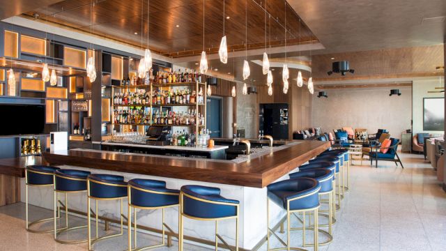 a bar with blue stools and a counter